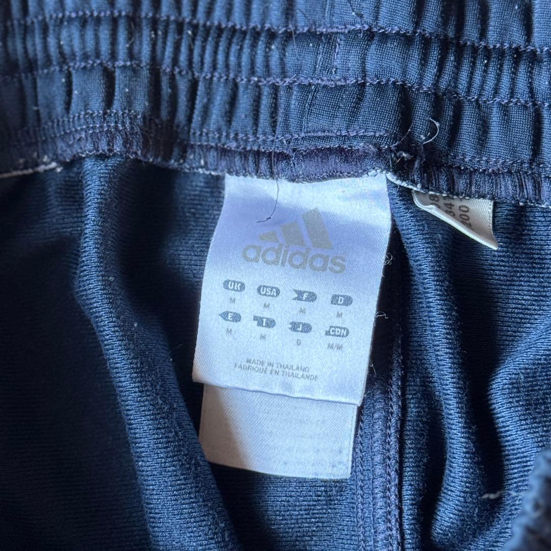 adidas ストライプジャージパンツ ブラック/オレンジ