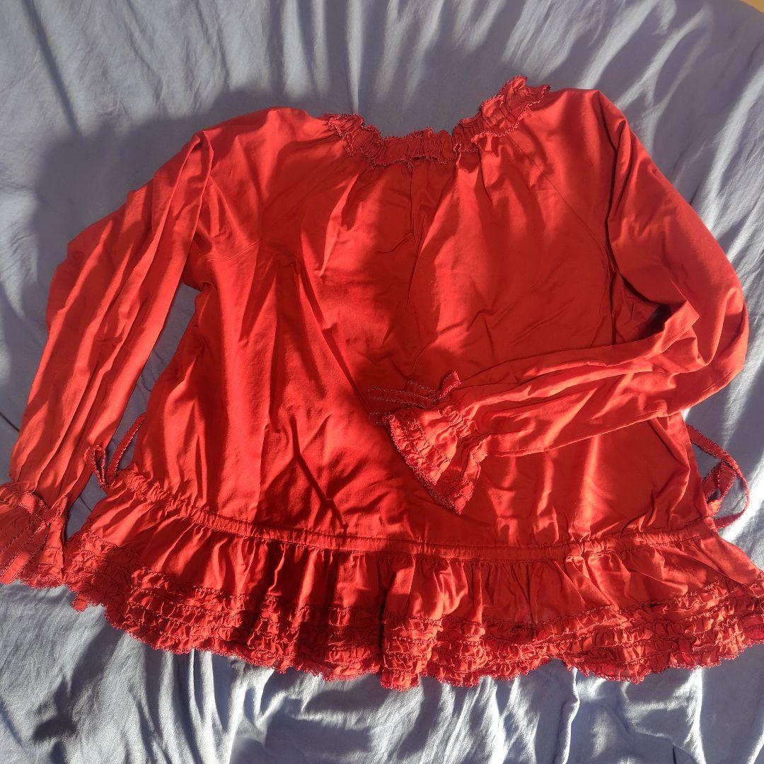赤いフリル付き長袖ブラウス